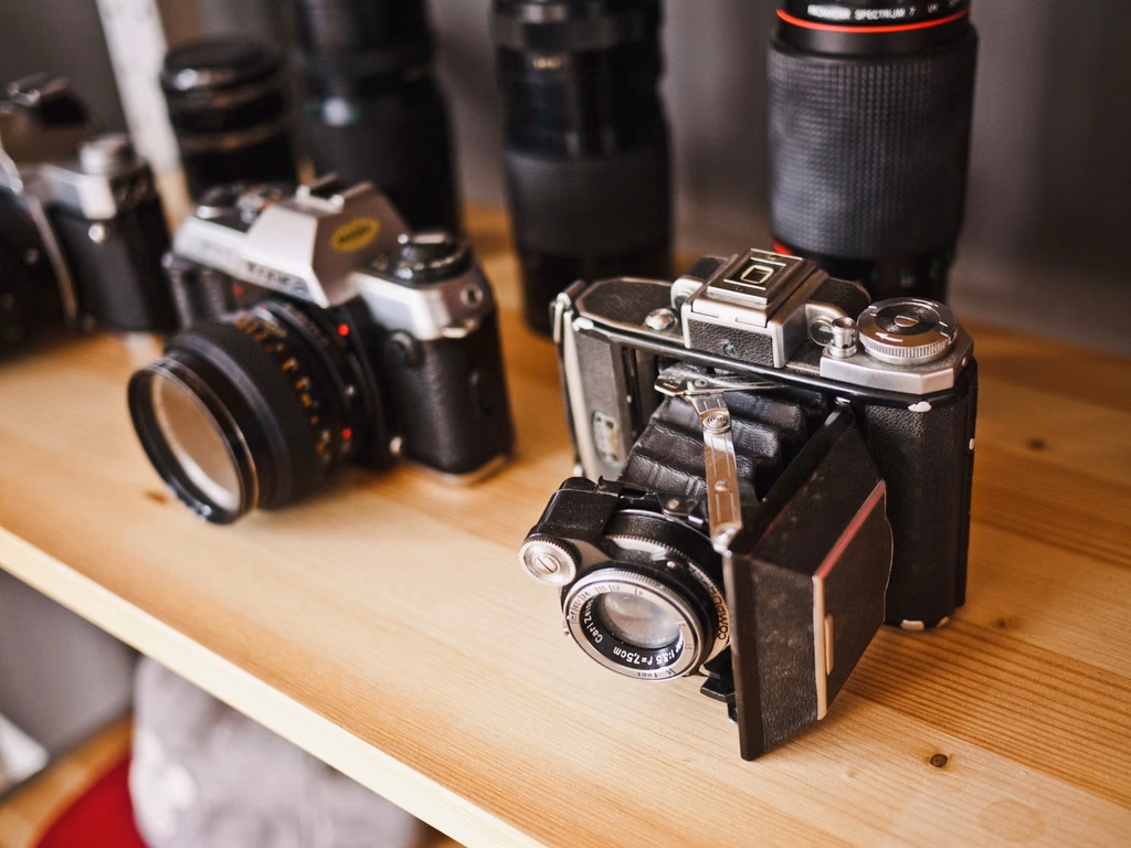Vintage cameras and lenses on a shelf