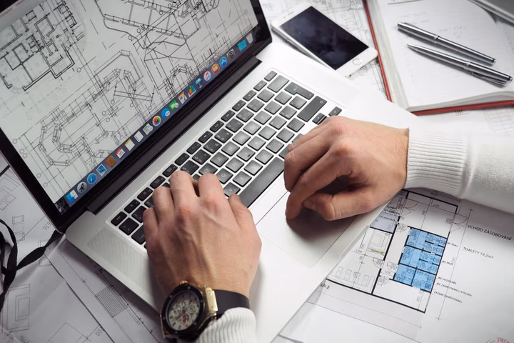 A person working at a desk with a laptop