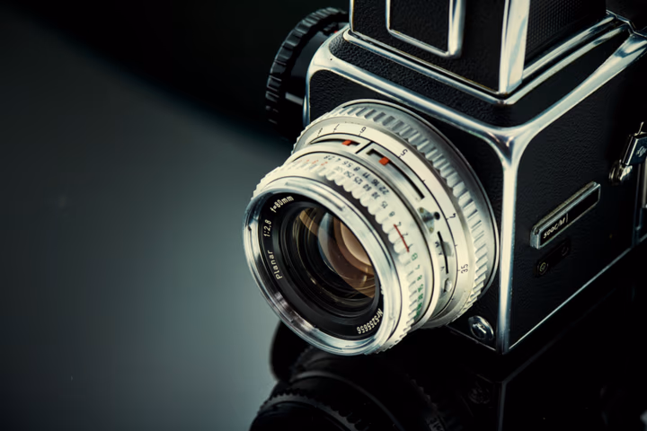 A classic film camera on a wooden surface