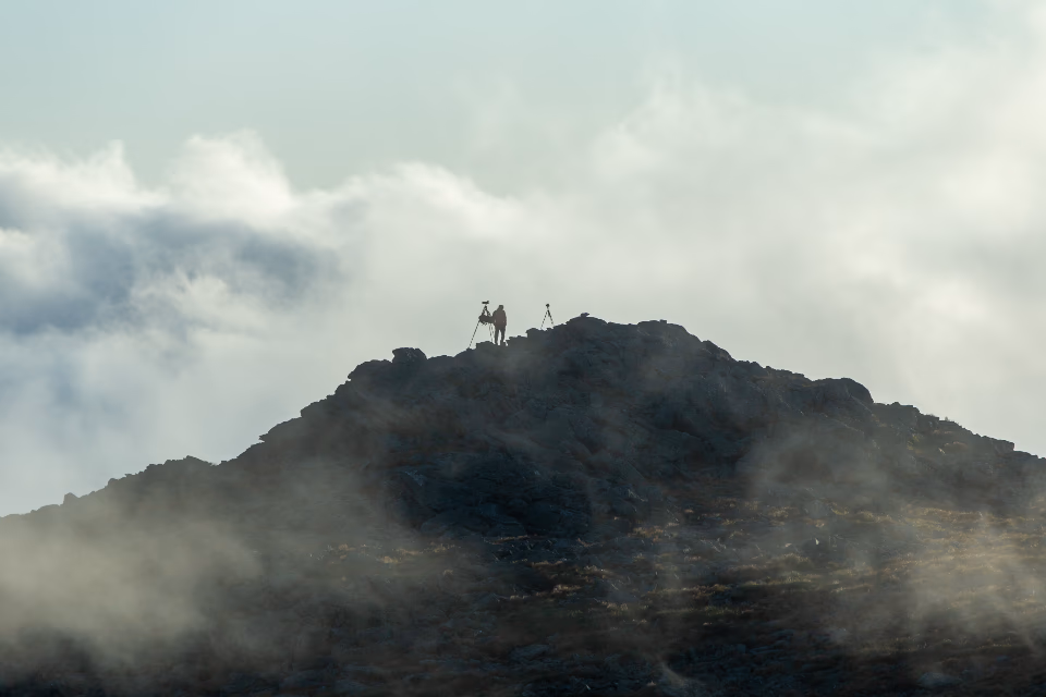A photographer in a mountain landscape