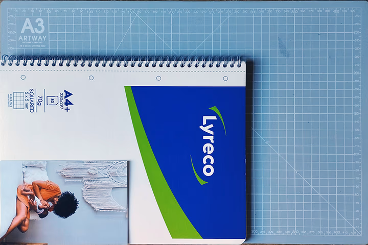 A physical 4x6 print held in a hand next to a ruler for exact size reference